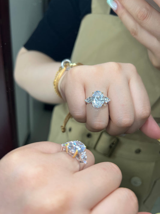 Elegance Three Stone With Pear Side Stone Engagement Ring